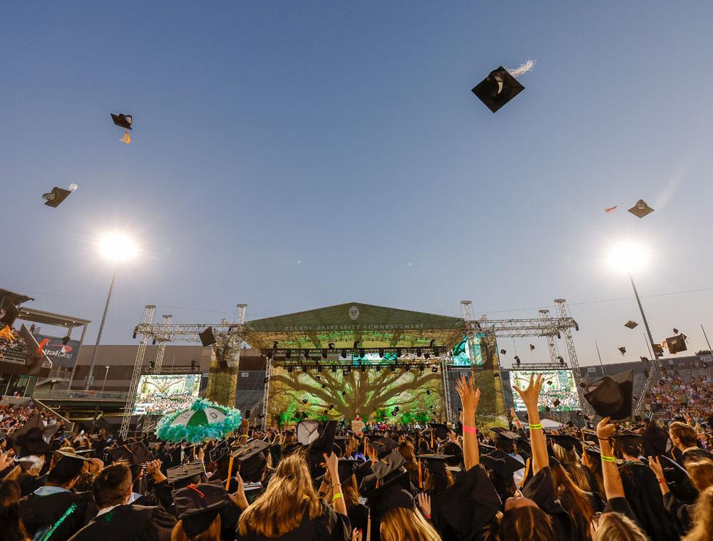 Graduates celebrate their Commencement by throwing their hats in the air. (Photo by Tyler Kaufman)