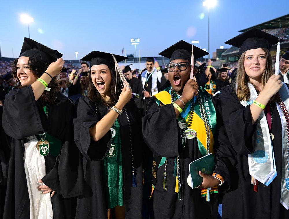 Graduates turn the tassels on their mortarboards, representing their shift from students to graduates. (Photo by Cheryl Gerber)