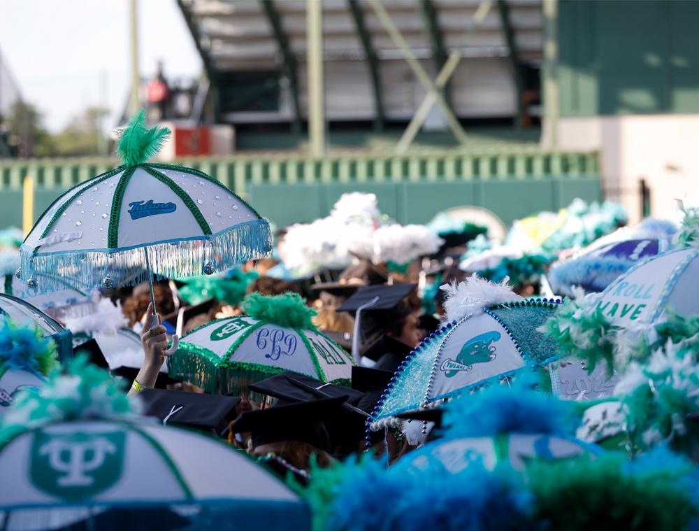 With their decorated second-line umbrellas in hand, excited graduates celebrate at the ceremony. Students are given plain umbrellas at their Convocation and encouraged to adorn them with memorabilia throughout their time at Tulane. (Photo by Tyler Kaufman)