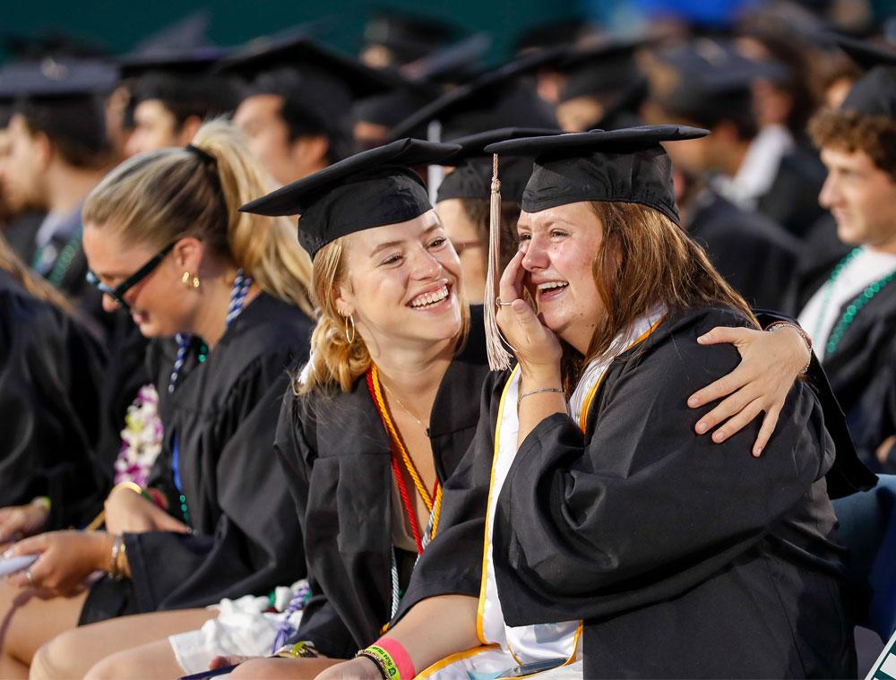 Elated students smile at each other as they celebrate together. (Photo by Tyler Kaufman)