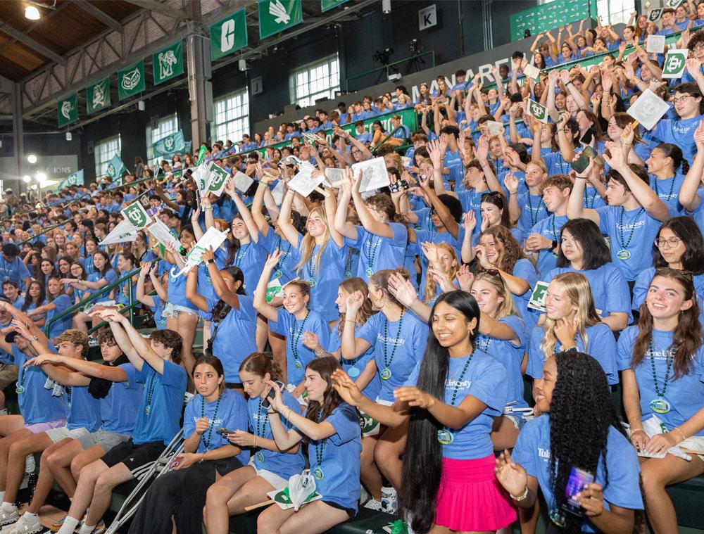 Students in the Class of 2028 cheer at the President's Convocation for New Students. 