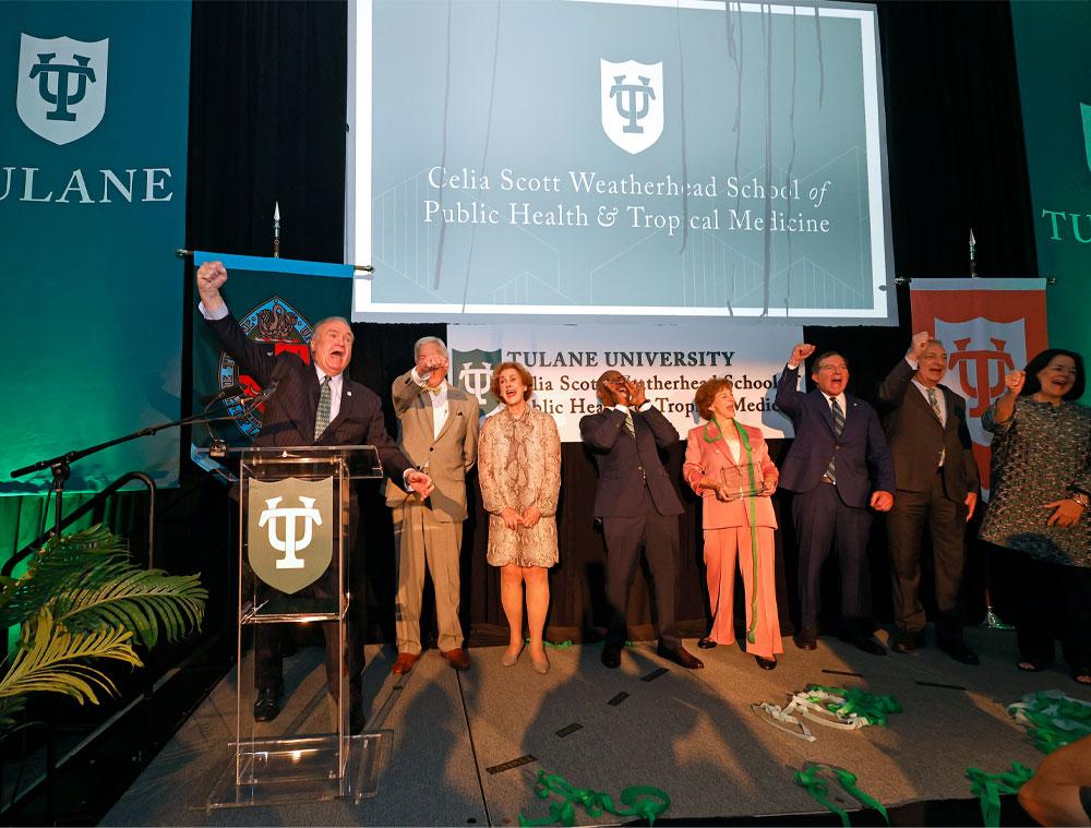 Fitts (far left) leads a hearty cheer as green streamers fall in celebration of the announcement. 