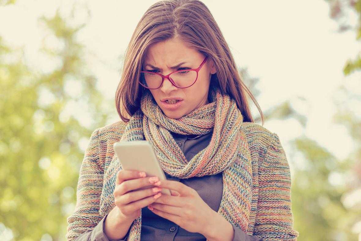 Woman scowls at phone