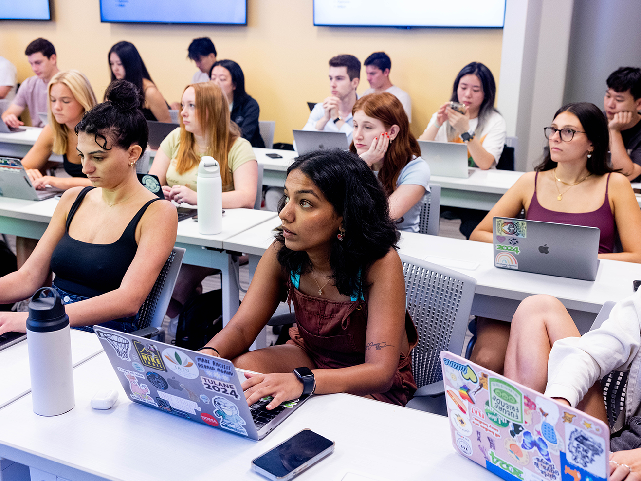 Students with laptops in a classroom