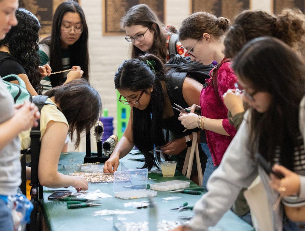 Students make charm bracelets. 