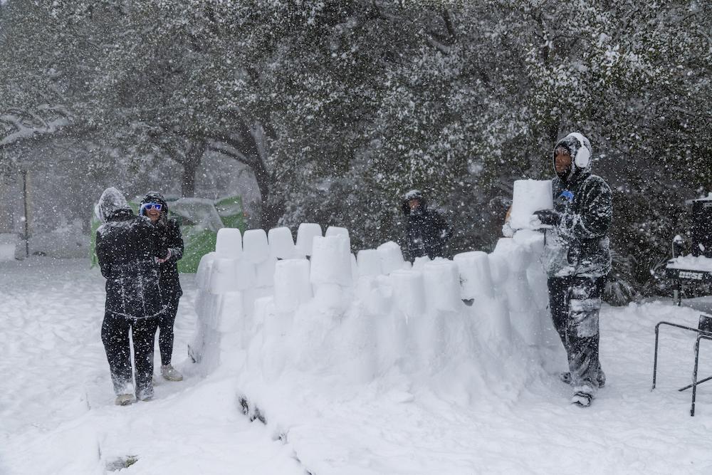 Students building a snow fort 