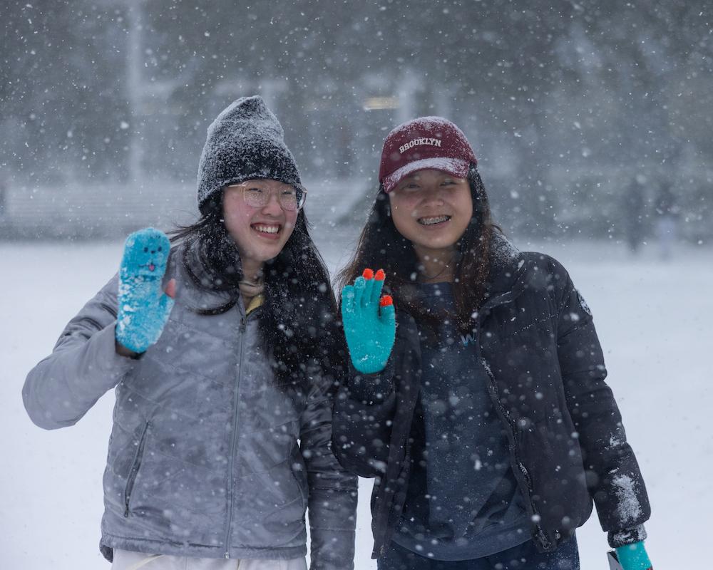 Two students smiling in the snow