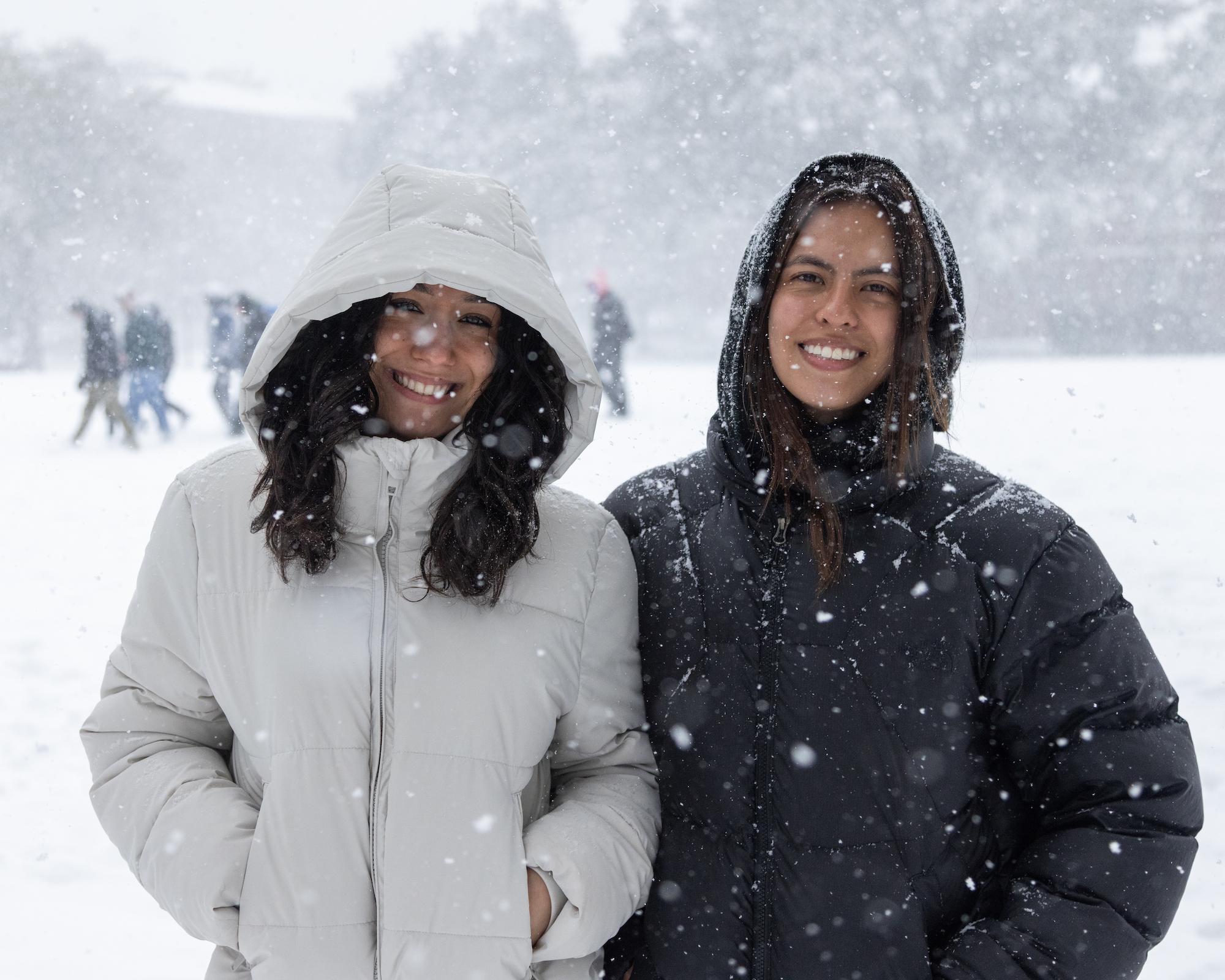 Two students smiling in the snow