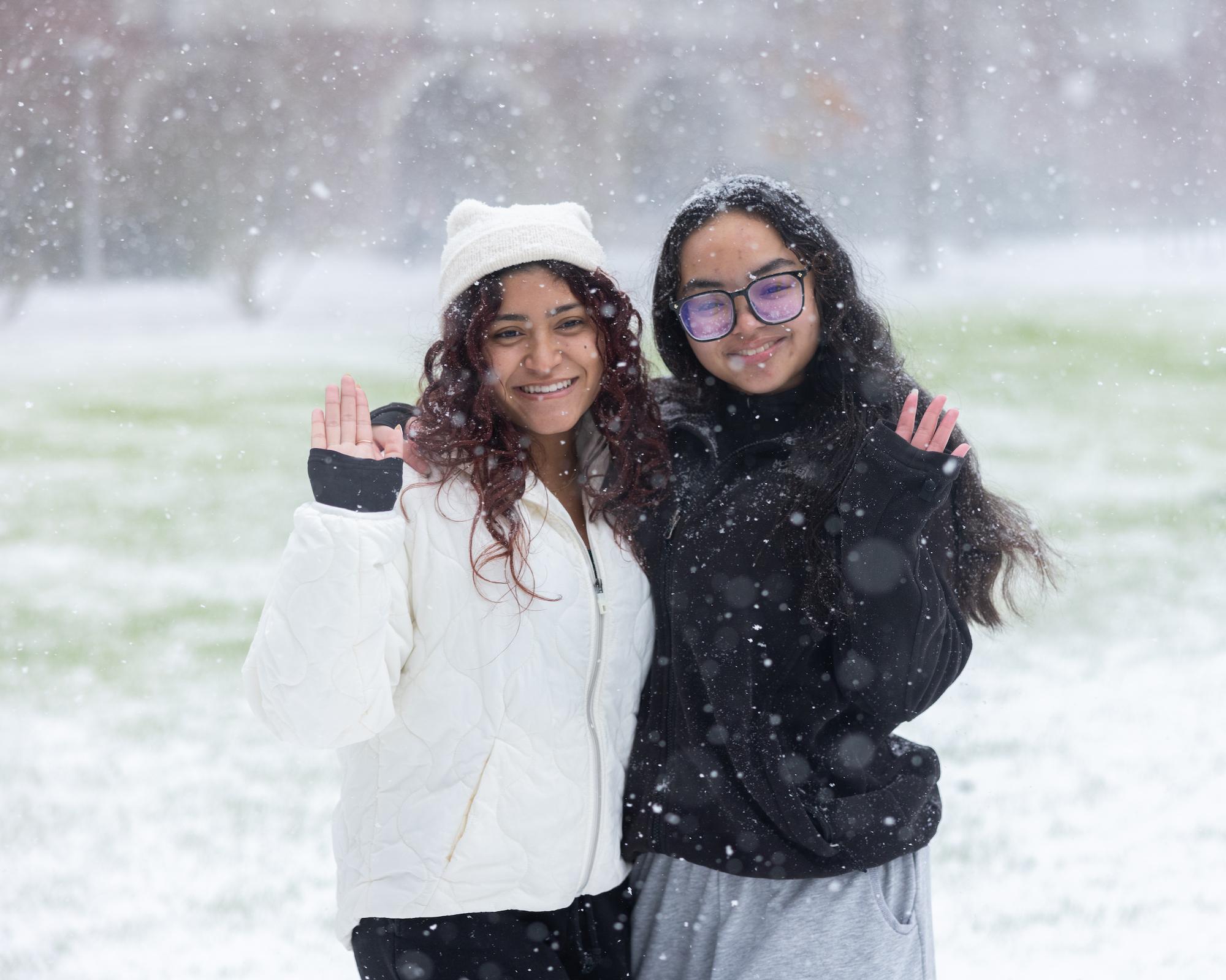 Two students posing in the snow 