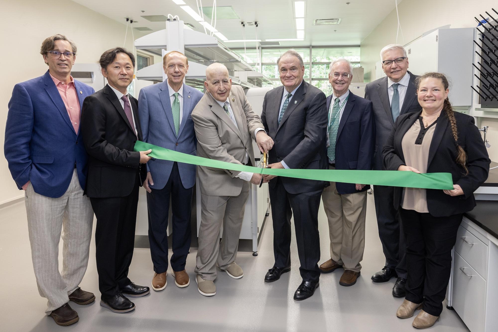 President Mike Fitts cuts the ribbon with researchers at the new Primate Center building