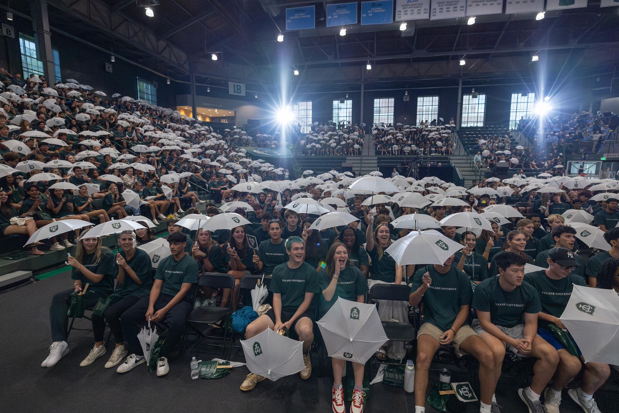 The audience at Convocation with white umbrellas