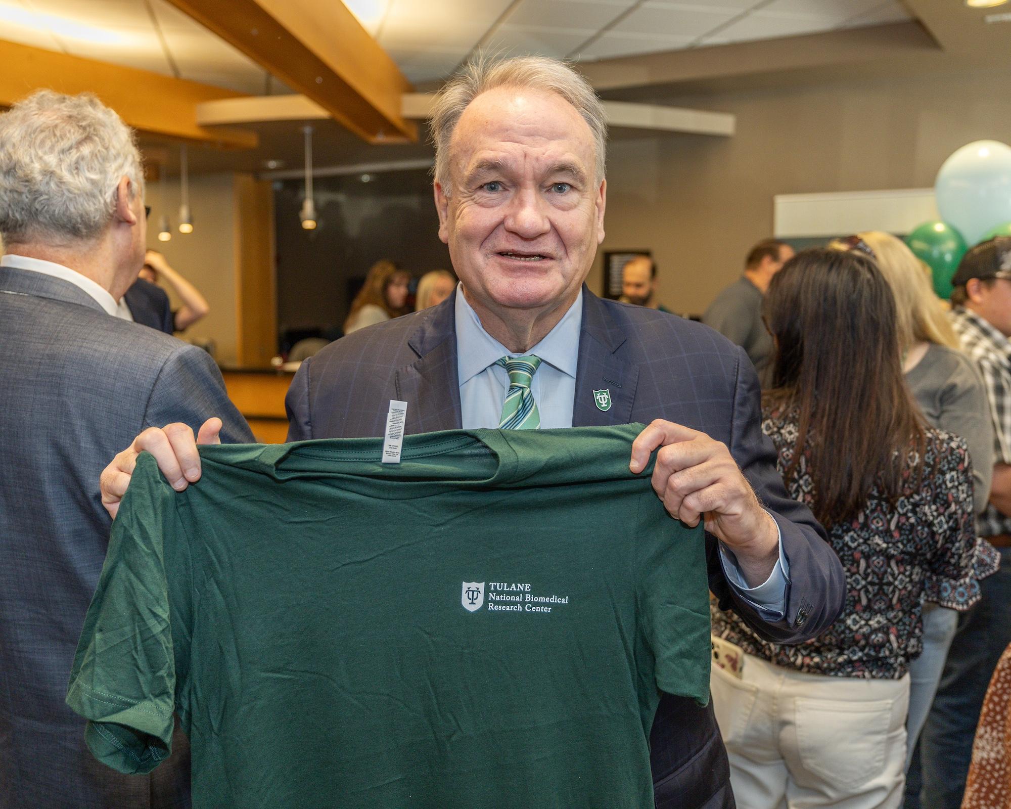 President Michael A. Fitts holding t-shirt President Michael A. Fitts holding t-shirt