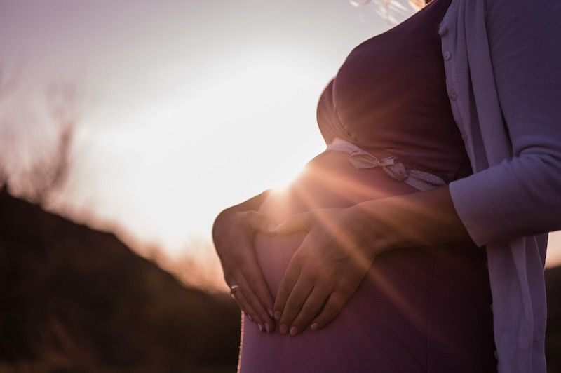 Pregnant woman in setting sun