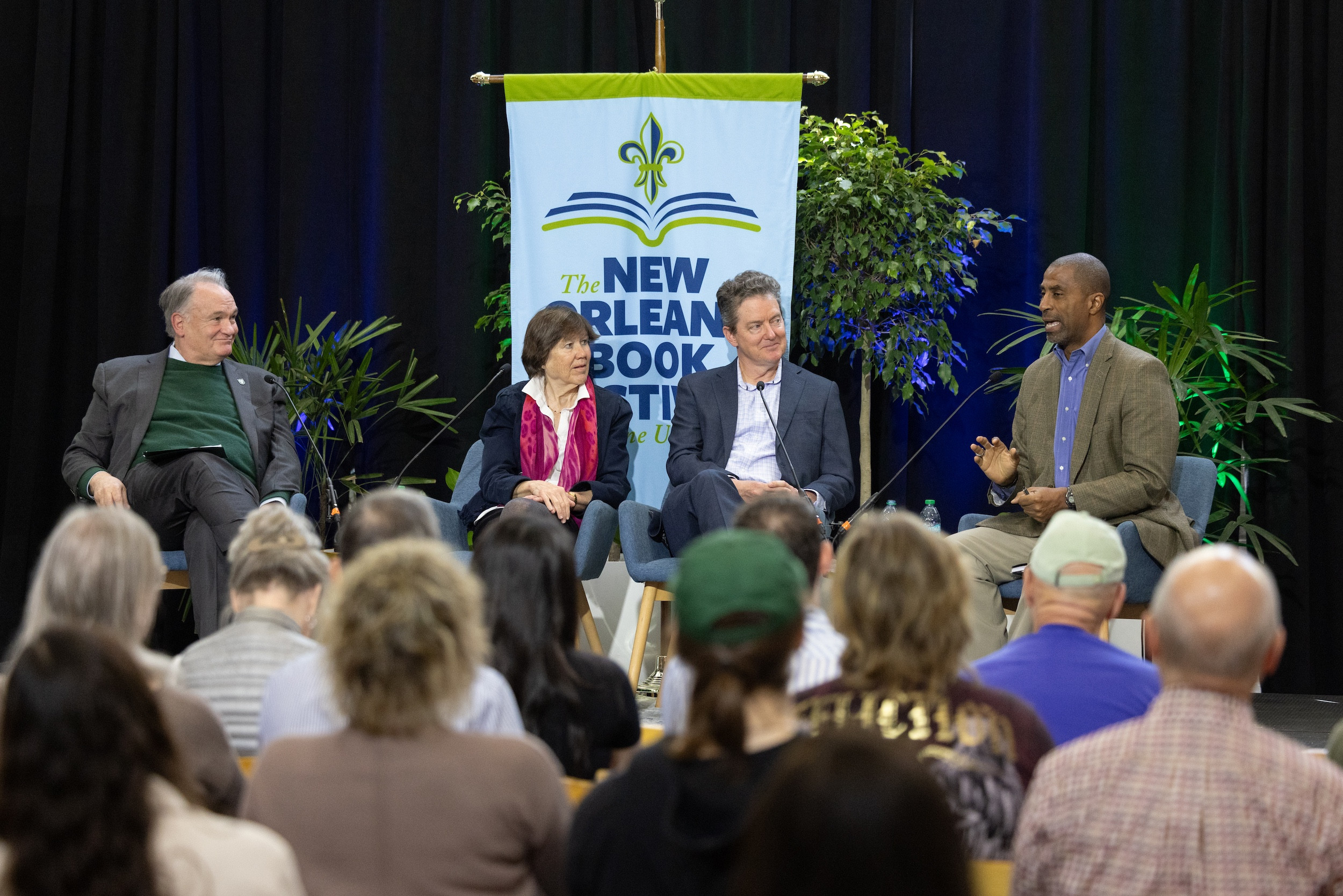 Panel discussion at The New Orleans Book Festival with four speakers and an audience.
