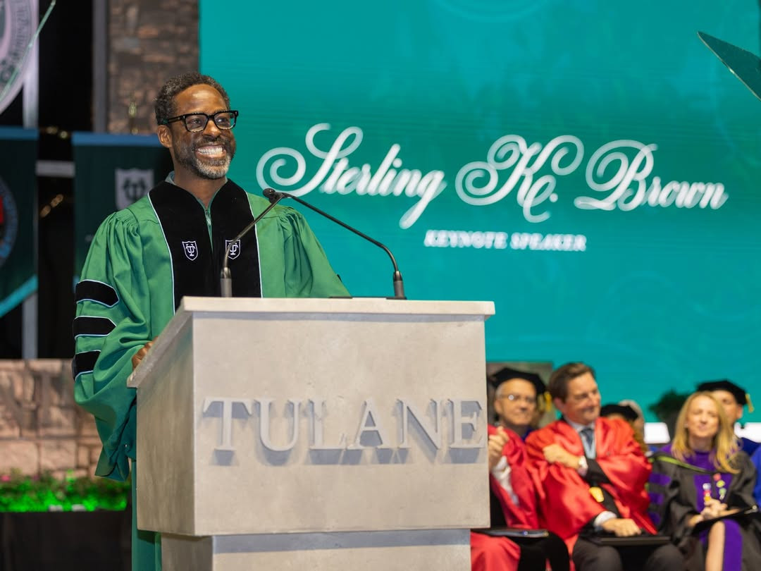 Sterling K. Brown, keynote speaker, smiles at a Tulane podium.