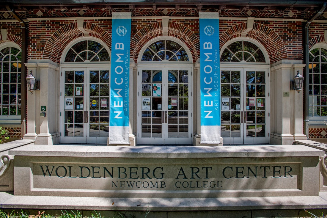 Woldenberg Art Center entrance with arched doors and "Newcomb" banners.