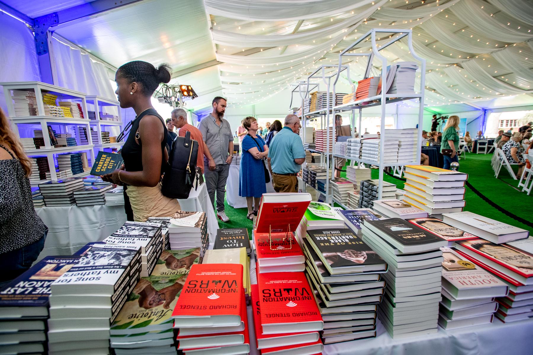 Attendees browse books for sale by featured Book Fesitval authors in between panels.