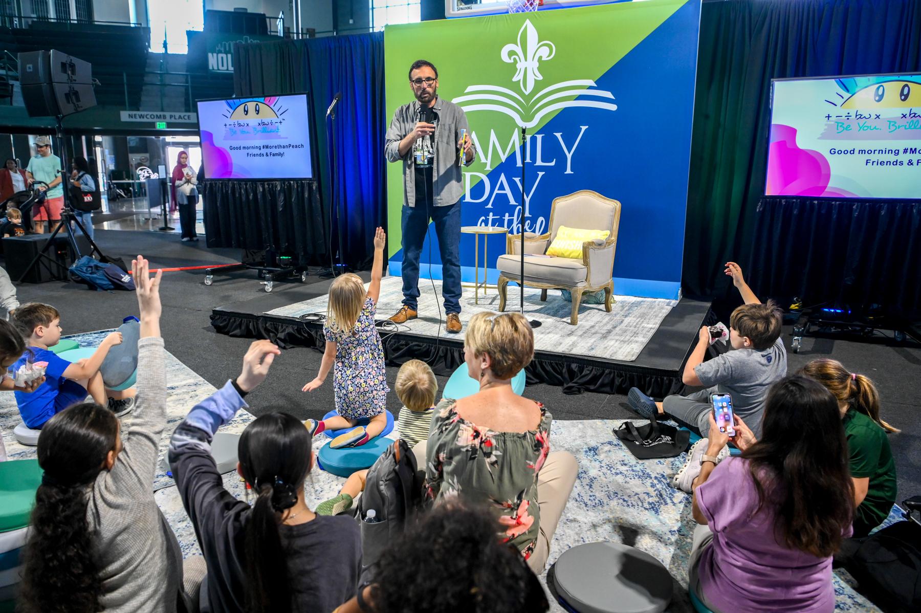 Mike Strecker, Tulane’s assistant VP of communications and marketing, fields question from the young audience at the Family Day event in Fogelman Arena.  Fifty Tulane faculty, staff and alums appeared on panels discussing various topics during the 3-day f