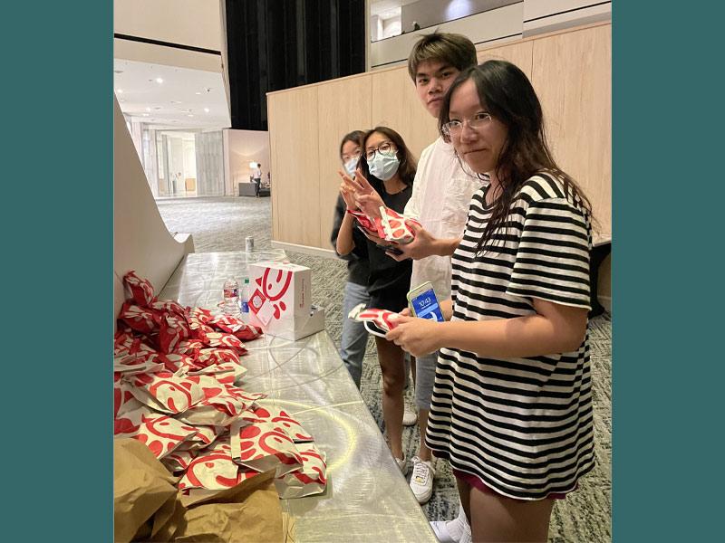 Students at the Hyatt Regency in downtown Houston pick up food from Chik-fil-a provided by LSU football, who also evacuated.  