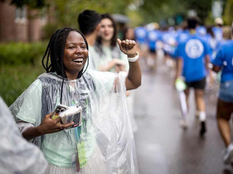 Wave Leaders cheer on the new students as they walk down out of the arena and down McAlister Way. 