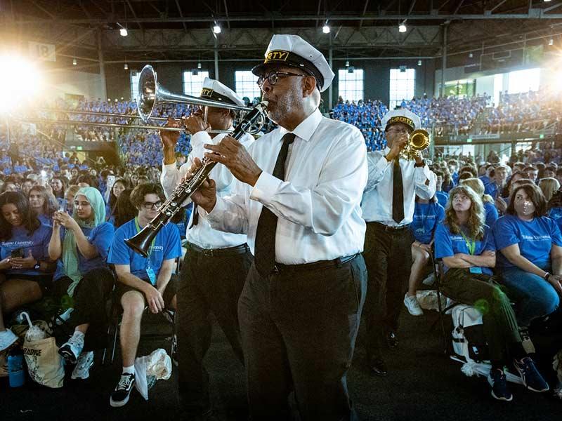 Dr. Michael White (center) and the Original Liberty Brass Band lead the procession to the stage. 