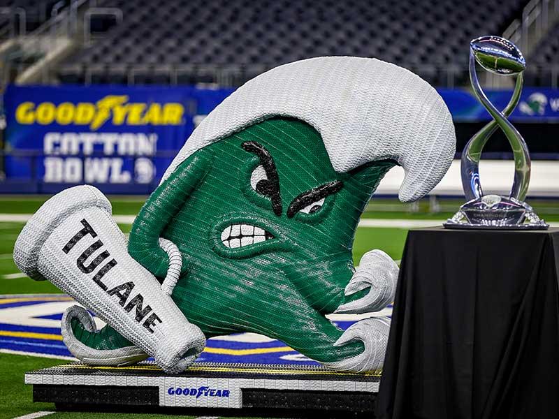 Angry Wave mascot created from Goodyear tires with Cotton Bowl trophy