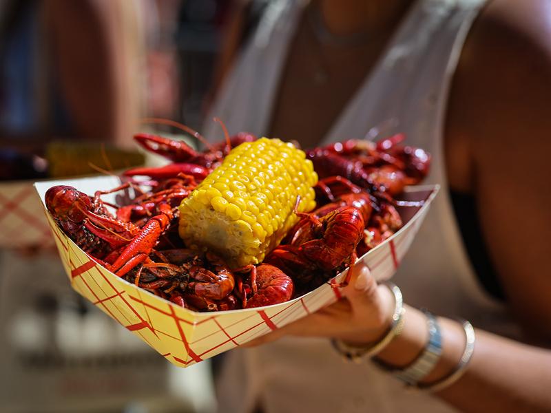 Cartons of crawfish and corn are handed out to students, family, and friends at Crawfest 2023. 
