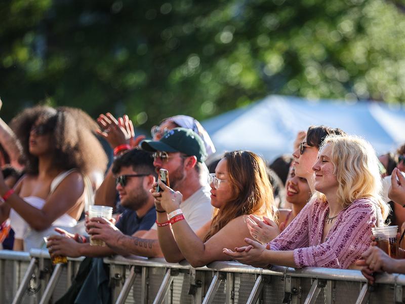 Students, family, and friends take in the performance from Tank and the Bangas at Crawfest.