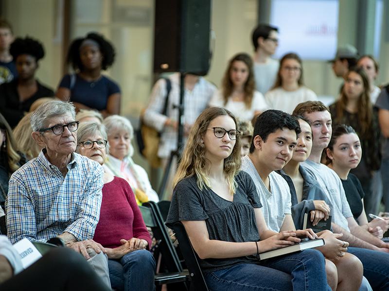 Attendees listen intently to the discussion.