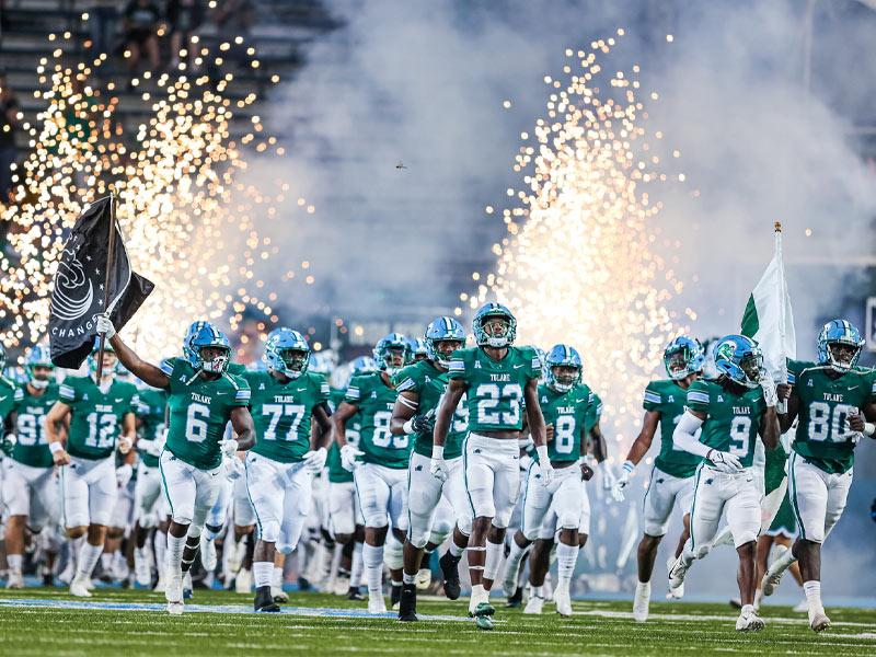 The Green Wave football team enter Benson Field in Yulman Stadium for the first game of the season held on the uptown campus since Ida caused Tulane Athletics to relocate team operations to Birmingham, Alabama.