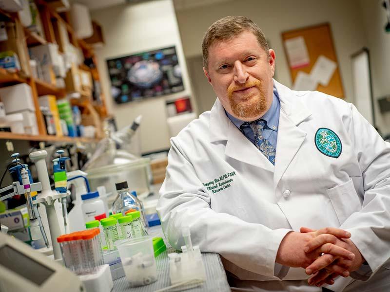 Dr. Gregory Bix in his lab