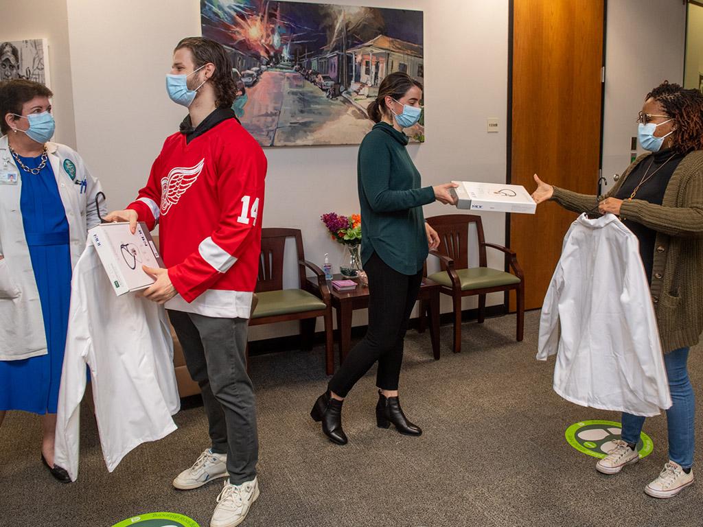 Handing out coats and stethoscopes at Tulane White Coat Ceremony