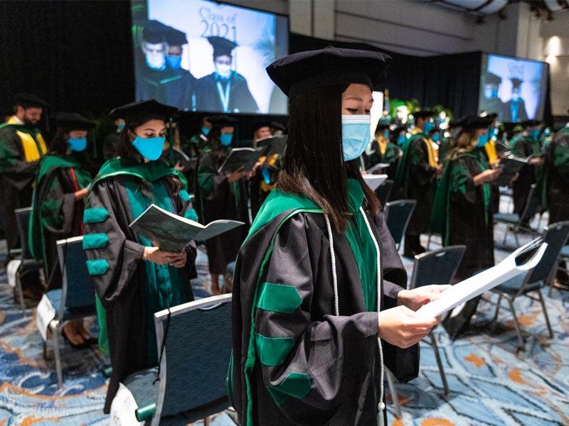 The newly conferred doctors recite the Hippocratic Oath.