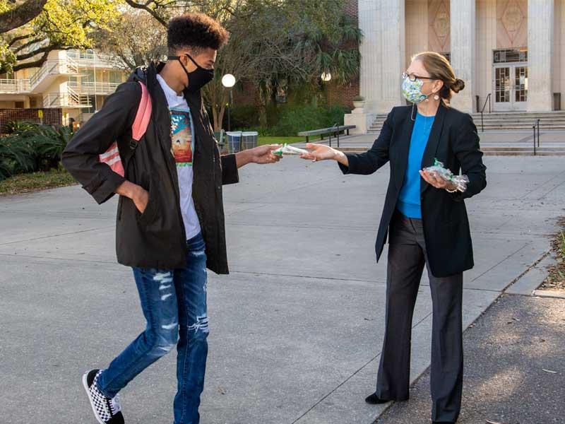 Lauren Osteen, Assistant Vice President of Campus Life, hands out cookies for the new program Moments of Joy