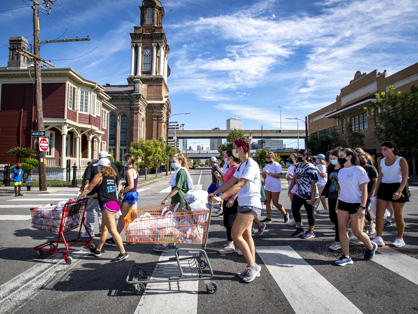 Students cross Oretha Castle Haley Blvd on their way to distribute bag lunches to a homeless community the Central City neighborhood. 