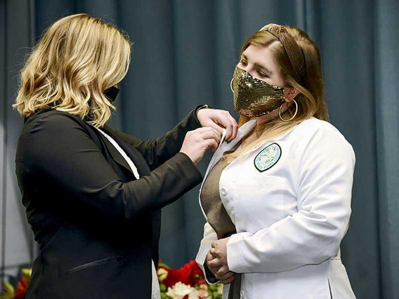 Jillian Aveni receives pin from program director Sarah Garner Jillian Aveni receives pin from program director Sarah Garner