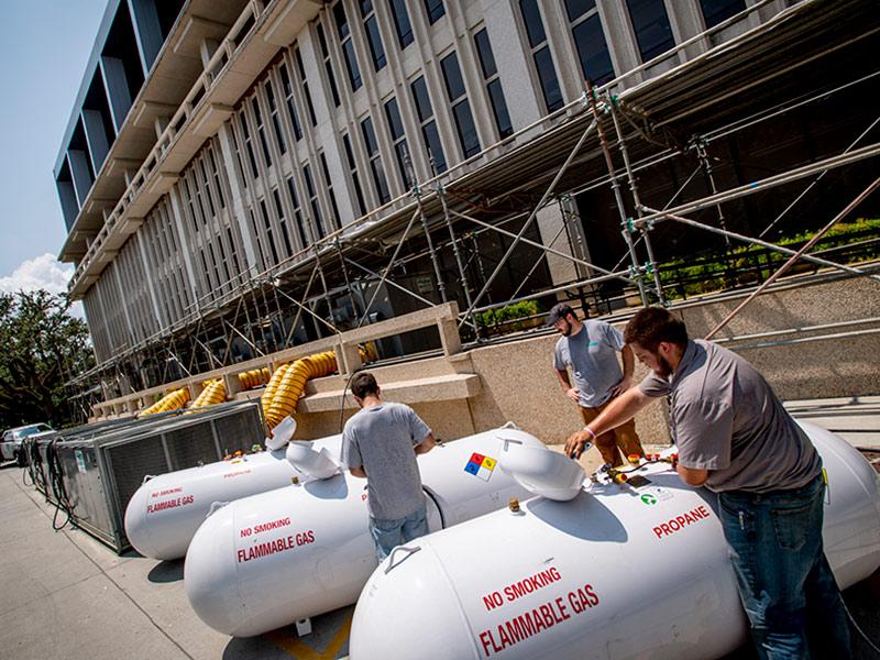 Campus Services staff and contractors manage the fuel for the generators that power the temporary HVAC system for the Howard-Tilton Memorial library. 