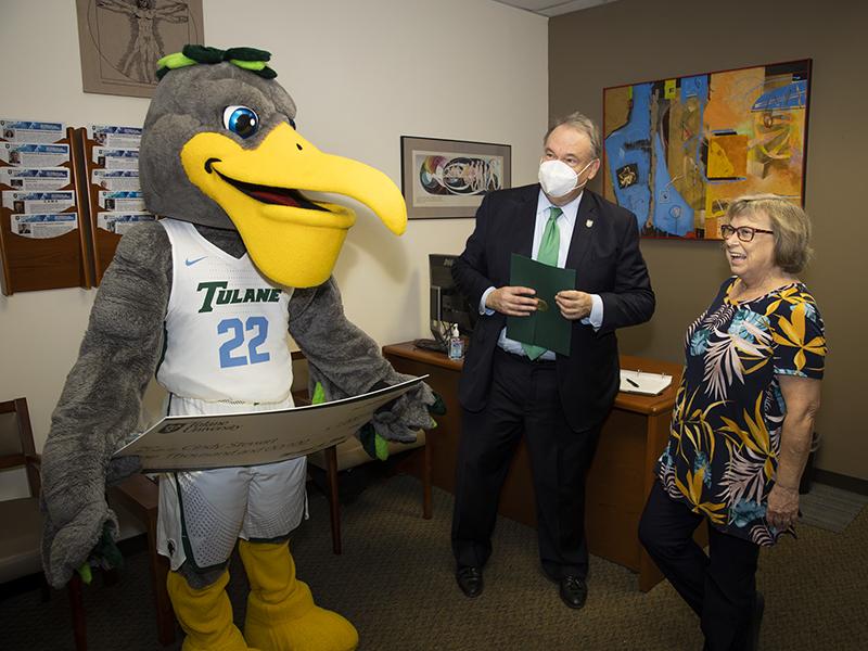 Cindy Stewart, senior executive secretary of the Department of Biomedical Engineering at the School of Science and Engineering, laughs with President Fitts and Riptide upon her award presentation. Cindy Stewart, senior executive secretary of the Department of Biomedical Engineering at the School of Science and Engineering, laughs with President Fitts and Riptide upon her award presentation.