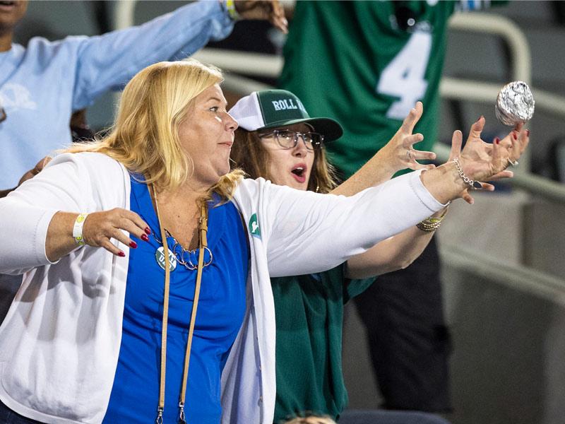 Fans reach for a T-shirt thrown into the stands. 