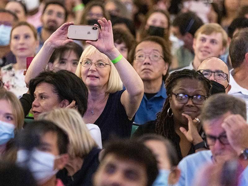 A proud loved one captures a moment at the ceremony as students are recognized on stage. 