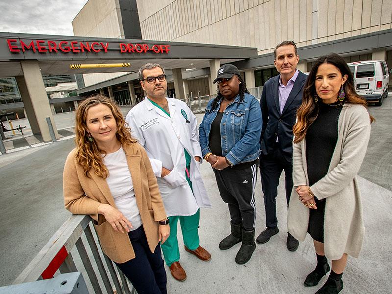 Gun violence researchers in front of hospital ER entrance