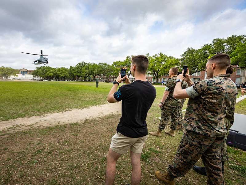 Students watch and record the AH-1 Super Cobra as it lands on the Berger Family Lawn.