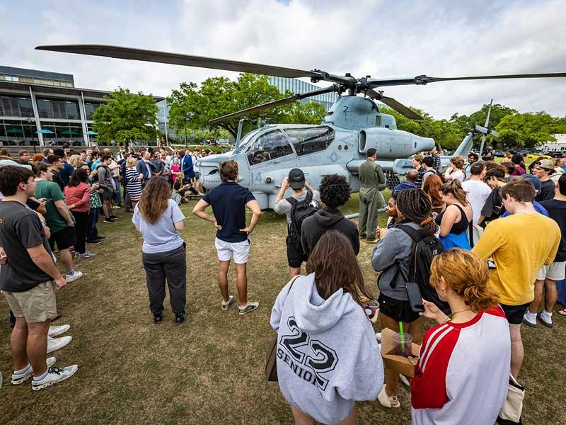 Students, staff, faculty and others check out the AH-1 Super Cobra. 