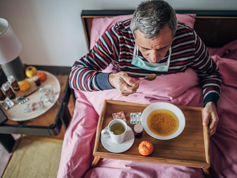 sick man eating soup