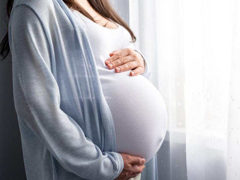 pregnant woman holds belly