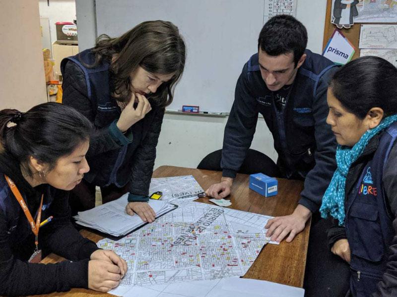 Blanca Delgado with Asociatión Benéfica PRISMA, Jessica Brewer, a SPHTM alumna and was a Fulbright Scholar at the time of the study, and Rafael​​​​​​​ Duran and Nelly Briceño with Asociatión Benéfica PRISMA review maps of Lima, Peru. 