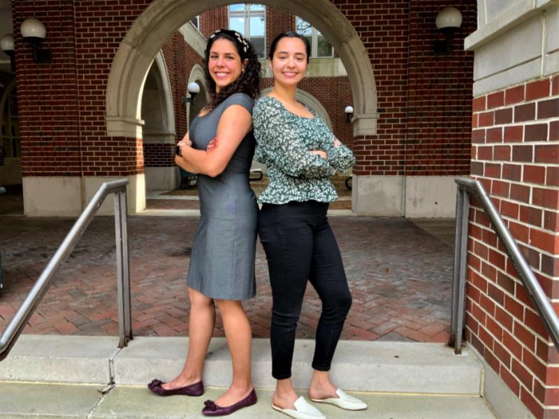Law students Gabriela Cruz and Sandra Zadeyeh stand back to back and pose for photo