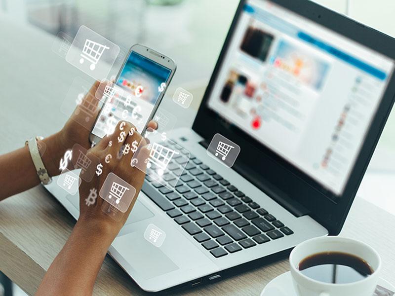Person using laptop and smartphone to analyze various information on futuristic virtual interface. Person using laptop and smartphone to analyze various information on futuristic virtual interface.
