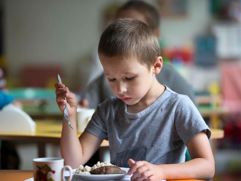 Child eating meal at table