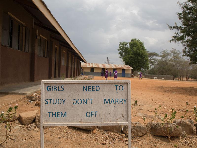 Sign that says Girls Need School Sign that says Girls Need School